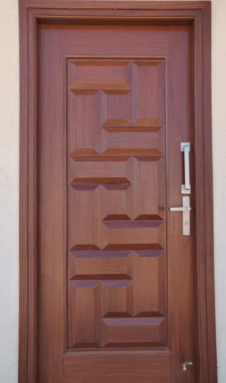 Panelled teak main door hand-finished and installed by Vishnu Timber Touch